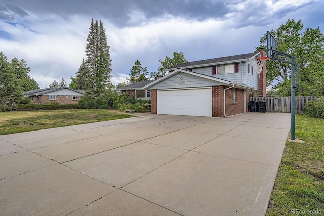 11290 W 77th Dr, Arvada, CO 80005 - view of front of house with brick siding, an attached garage, and driveway