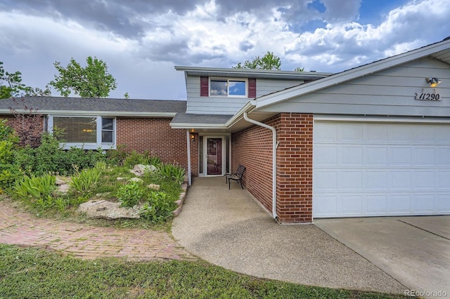 11290 W 77th Dr, Arvada, CO 80005 - traditional-style house with brick siding, an attached garage, and driveway