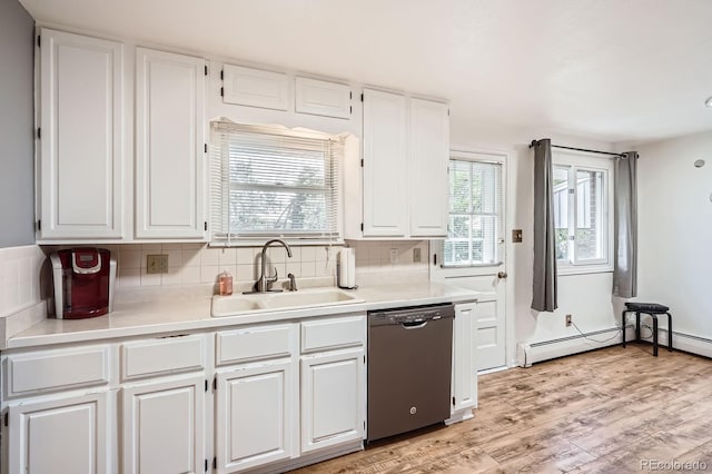 11290 W 77th Dr, Arvada, CO 80005 - kitchen featuring stainless steel dishwasher, white cabinetry, baseboard heating, decorative backsplash, and light countertops
