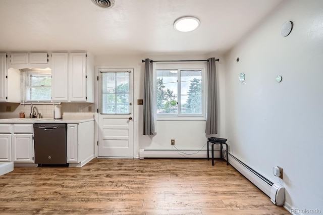 11290 W 77th Dr, Arvada, CO 80005 - kitchen with stainless steel dishwasher, baseboard heating, white cabinets, light countertops, and light wood-style floors
