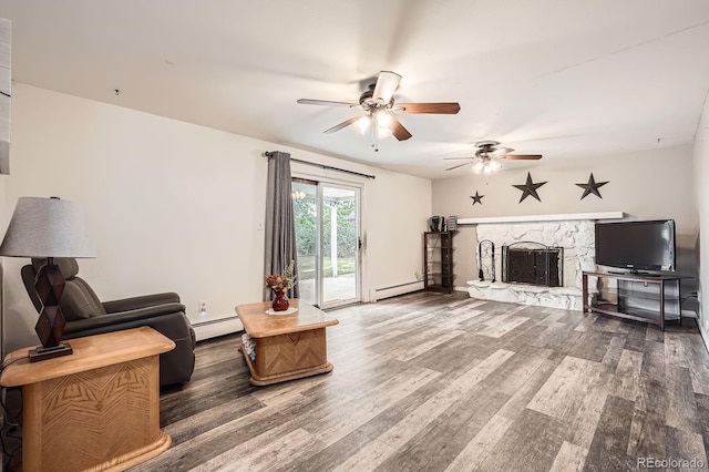 11290 W 77th Dr, Arvada, CO 80005 - living room featuring baseboard heating, ceiling fan, a baseboard heating unit, a stone fireplace, and wood finished floors