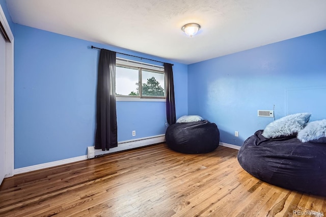 11290 W 77th Dr, Arvada, CO 80005 - sitting room with a baseboard radiator and hardwood / wood-style flooring