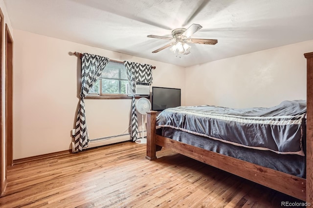 11290 W 77th Dr, Arvada, CO 80005 - bedroom with a baseboard heating unit, light wood-style flooring, ceiling fan, and cooling unit