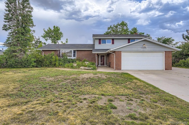 11290 W 77th Dr, Arvada, CO 80005 - view of front of property featuring brick siding, a garage, driveway, and a front yard