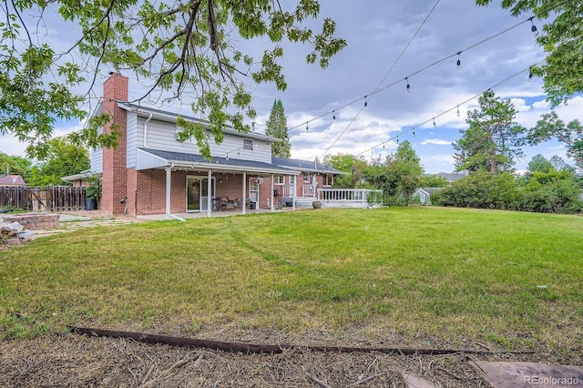 11290 W 77th Dr, Arvada, CO 80005 - back of property featuring a chimney, brick siding, and a patio area