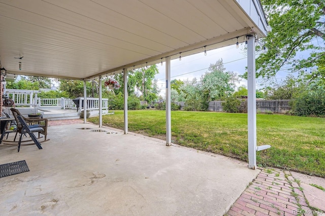 11290 W 77th Dr, Arvada, CO 80005 - fenced backyard featuring a patio and a wooden deck