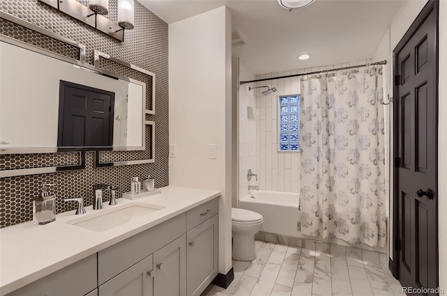 full bathroom with decorative backsplash, toilet, marble finish floor, shower / bath combo with shower curtain, and vanity