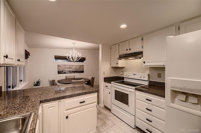 kitchen with white appliances, dark countertops, white cabinetry, and under cabinet range hood