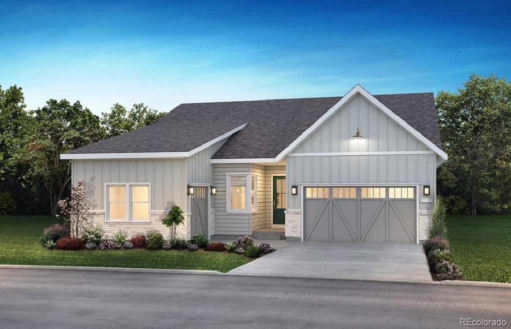 view of front of house with a garage and a front yard