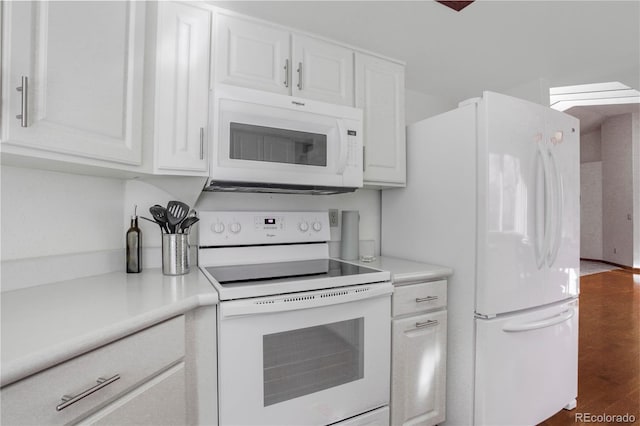 kitchen featuring white appliances, dark wood-style floors, white cabinetry, and light countertops