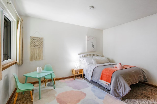 carpeted bedroom featuring baseboards