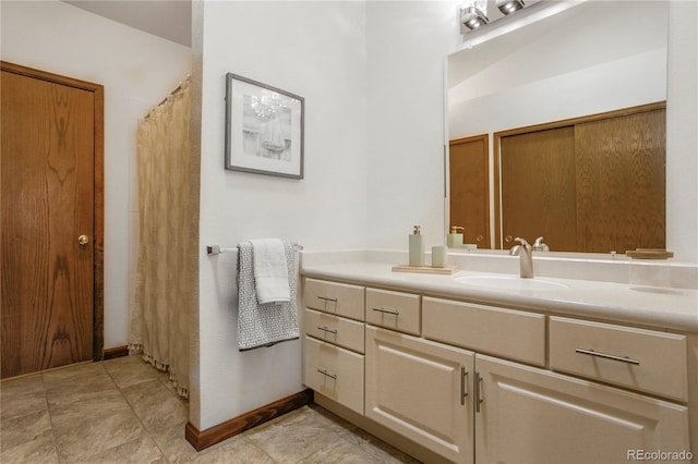 bathroom featuring baseboards and vanity