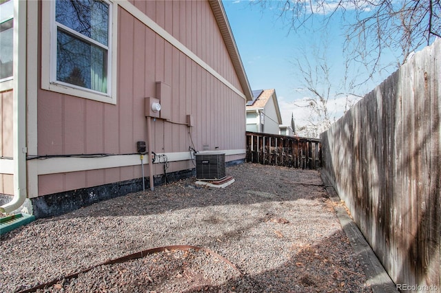 view of property exterior featuring a fenced backyard and central AC unit