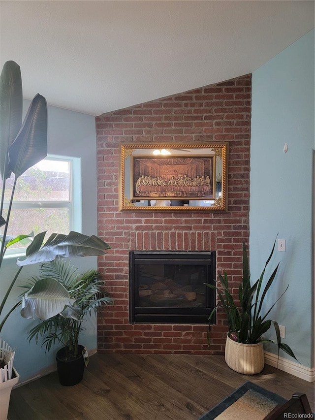 living room featuring a fireplace, lofted ceiling, and dark hardwood / wood-style floors