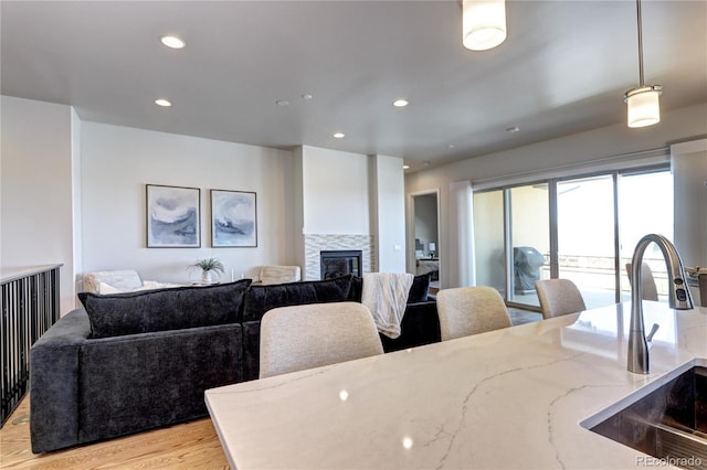365 Casalon Pl, Superior, CO 80027 - dining room with a glass covered fireplace, recessed lighting, and light wood finished floors