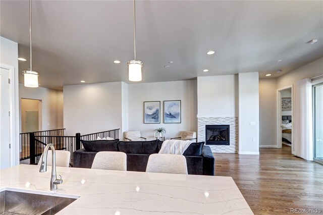 365 Casalon Pl, Superior, CO 80027 - living room featuring wood finished floors, recessed lighting, a glass covered fireplace, and baseboards