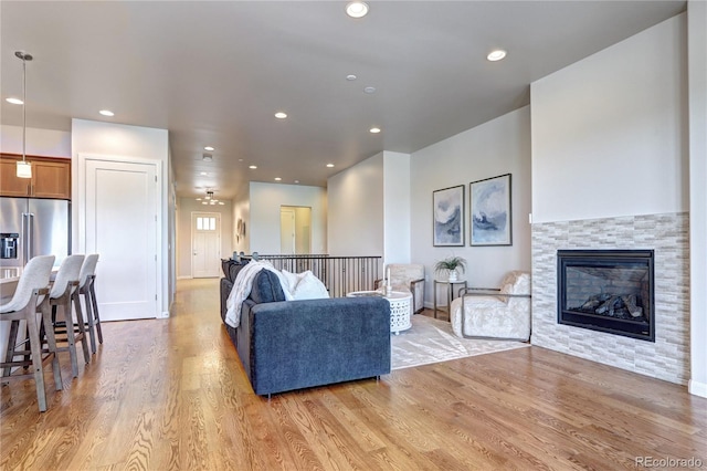 365 Casalon Pl, Superior, CO 80027 - living area featuring light wood-style flooring, a tile fireplace, and recessed lighting