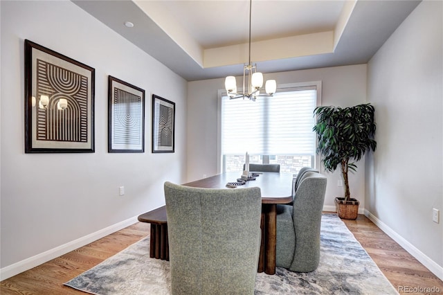 365 Casalon Pl, Superior, CO 80027 - dining space with a chandelier, a tray ceiling, light wood finished floors, and baseboards