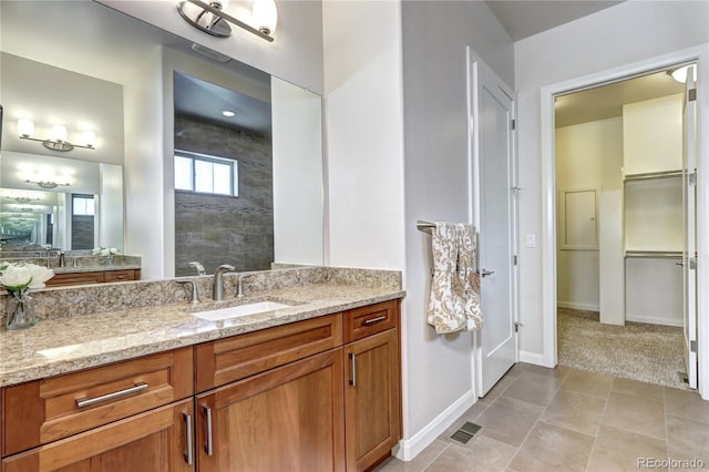 365 Casalon Pl, Superior, CO 80027 - bathroom with baseboards, vanity, tile patterned flooring, and a tile shower