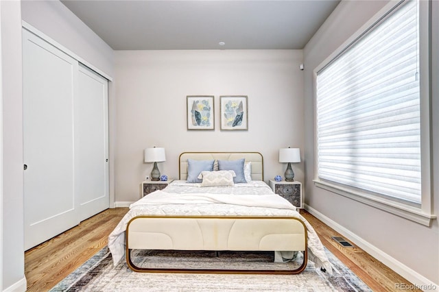 365 Casalon Pl, Superior, CO 80027 - bedroom with wood finished floors, multiple windows, and baseboards