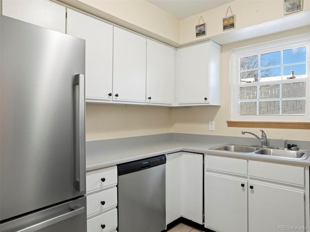 kitchen featuring white cabinets, stainless steel appliances, and sink