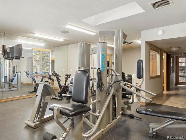 workout area featuring a textured ceiling and plenty of natural light