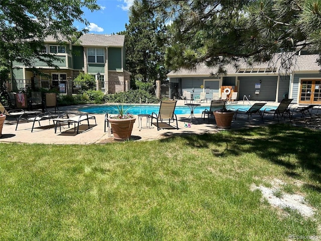 view of pool with a yard