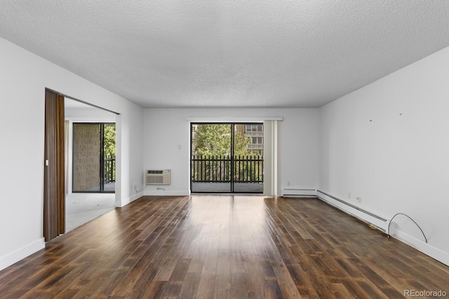 unfurnished living room with baseboard heating, dark wood-type flooring, a wall mounted air conditioner, and a textured ceiling