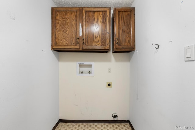 laundry area with washer hookup, hookup for an electric dryer, cabinets, and a textured ceiling