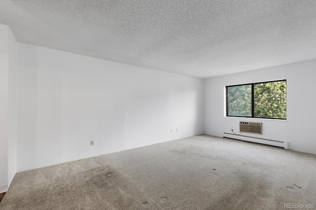 carpeted empty room featuring a textured ceiling and a baseboard heating unit