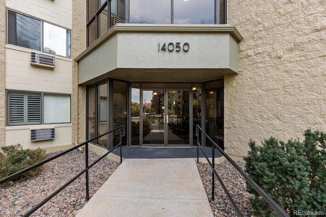 property entrance featuring a wall mounted air conditioner