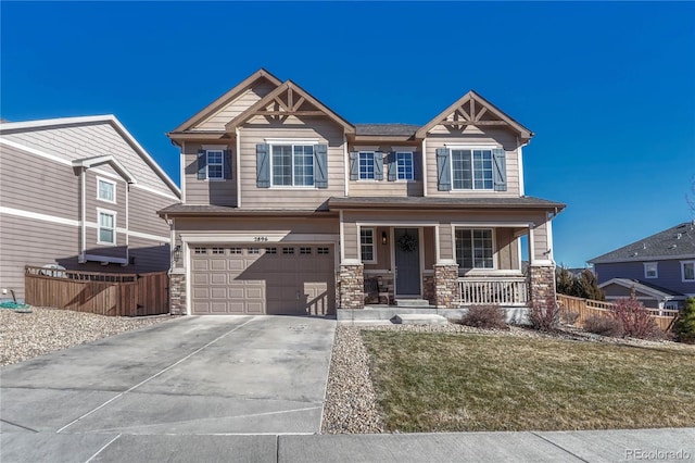 view of front of property with a porch, a garage, and a front yard