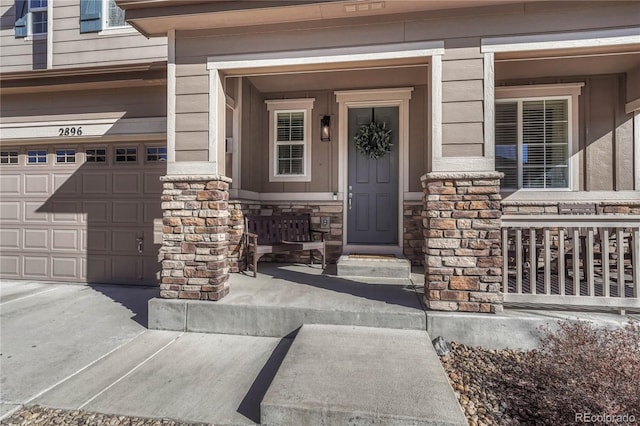 entrance to property with a garage and covered porch