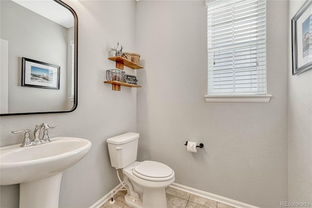 bathroom with sink, tile patterned floors, and toilet