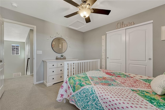 bedroom featuring ceiling fan, a closet, and light carpet