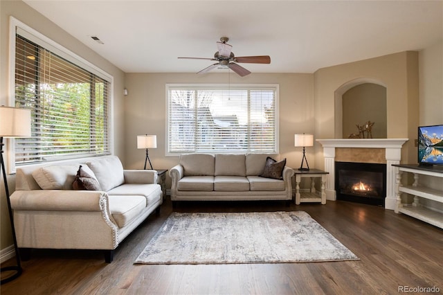 living room with ceiling fan and dark wood-type flooring