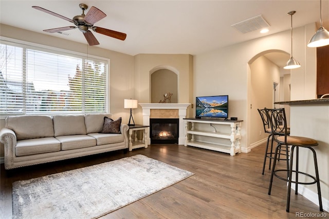 living room featuring dark hardwood / wood-style floors and ceiling fan