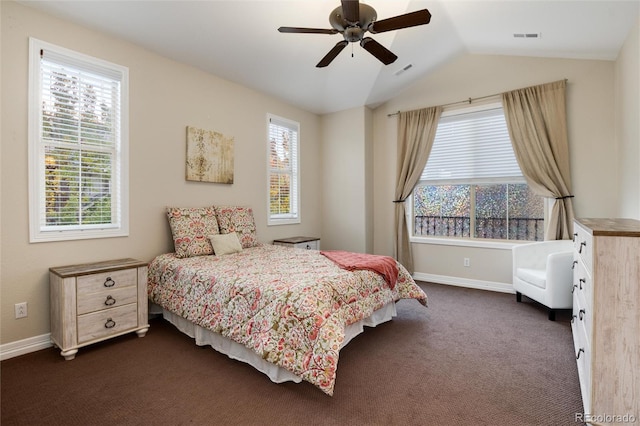 carpeted bedroom featuring multiple windows, lofted ceiling, and ceiling fan