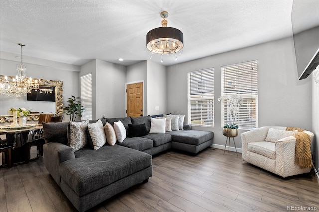 9758 Laredo St Unit 18D, Commerce City, CO 80022 - living area with a textured ceiling, baseboards, an inviting chandelier, recessed lighting, and hardwood / wood-style floors