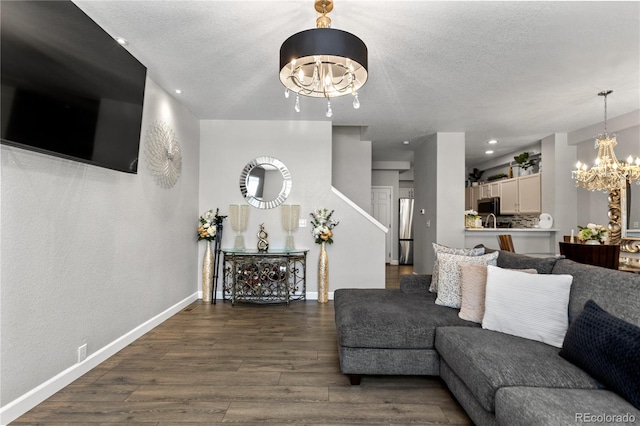 9758 Laredo St Unit 18D, Commerce City, CO 80022 - living area featuring baseboards, dark wood-style flooring, a textured ceiling, and a chandelier
