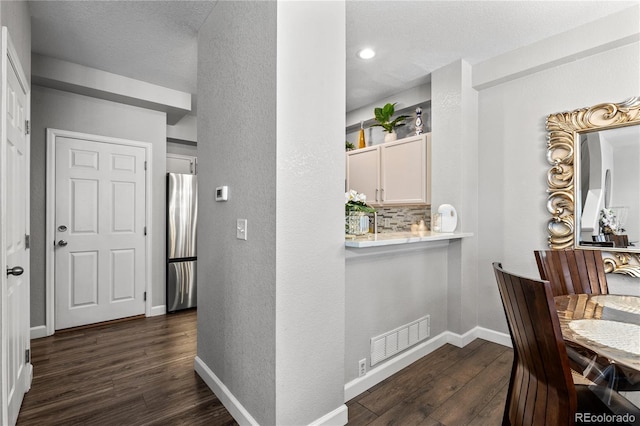 9758 Laredo St Unit 18D, Commerce City, CO 80022 - dining space featuring visible vents, dark wood finished floors, a textured wall, and baseboards
