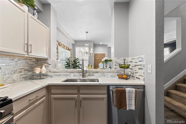 9758 Laredo St Unit 18D, Commerce City, CO 80022 - kitchen featuring tasteful backsplash, stainless steel dishwasher, light stone countertops, a sink, and a chandelier