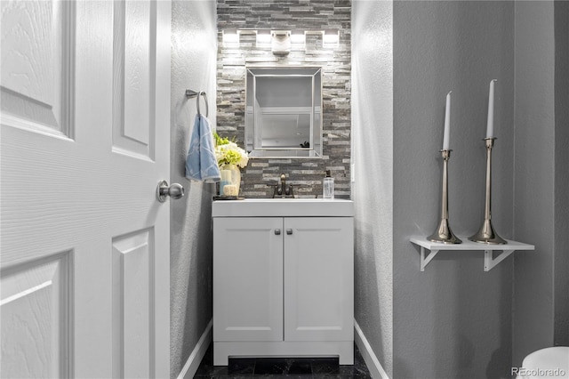 9758 Laredo St Unit 18D, Commerce City, CO 80022 - bathroom featuring vanity, baseboards, and a textured wall