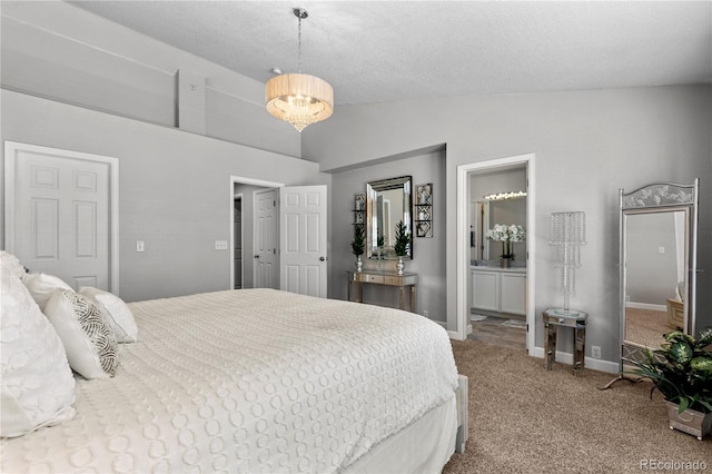 9758 Laredo St Unit 18D, Commerce City, CO 80022 - carpeted bedroom featuring baseboards, a textured ceiling, connected bathroom, and lofted ceiling