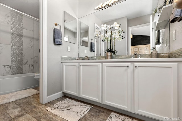 9758 Laredo St Unit 18D, Commerce City, CO 80022 - full bathroom featuring double vanity, bathtub / shower combination, wood finished floors, a sink, and toilet