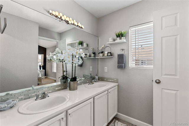 9758 Laredo St Unit 18D, Commerce City, CO 80022 - full bath featuring double vanity, baseboards, and a sink