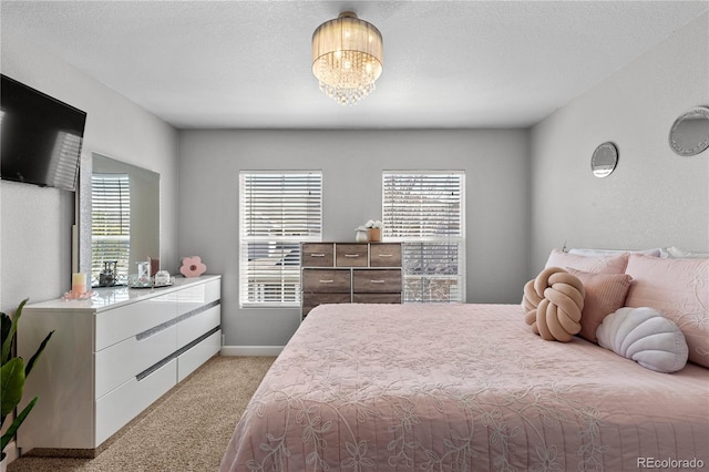 9758 Laredo St Unit 18D, Commerce City, CO 80022 - bedroom featuring light colored carpet, baseboards, a chandelier, and multiple windows