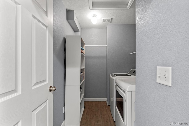 9758 Laredo St Unit 18D, Commerce City, CO 80022 - washroom with laundry area, visible vents, a textured wall, wood finished floors, and separate washer and dryer