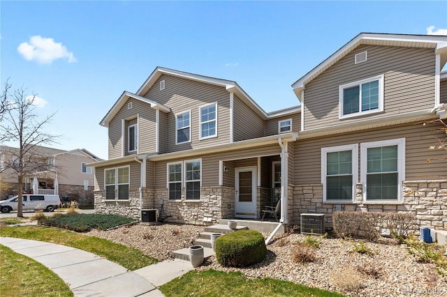 9758 Laredo St Unit 18D, Commerce City, CO 80022 - craftsman inspired home featuring a porch, central AC, and stone siding