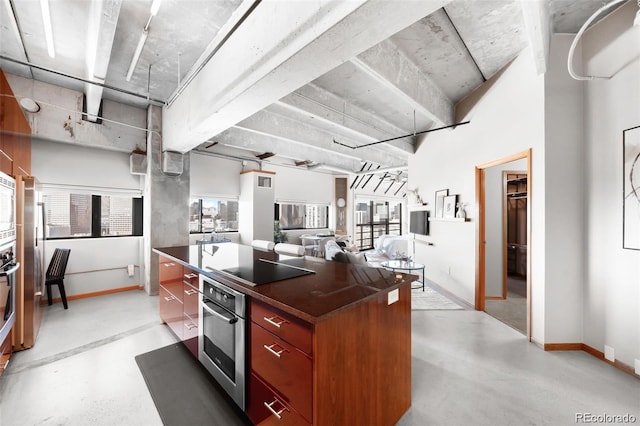 100 Park Ave Unit 2008, Denver, CO 80205 - kitchen featuring stainless steel appliances, dark countertops, concrete floors, and a kitchen island